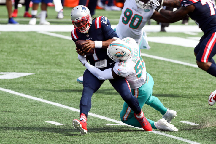 Miami Dolphins outside linebacker Jerome Baker (55) sacks New England Patriots quarterback Cam Newton (1) during the first quarter at Gillette Stadium.