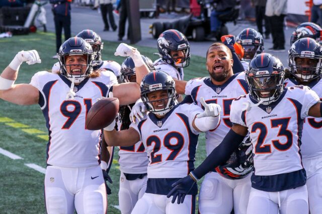 Broncos defense celebrates a turnover against New England. Credit: Paul Rutherford, USA TODAY Sports.