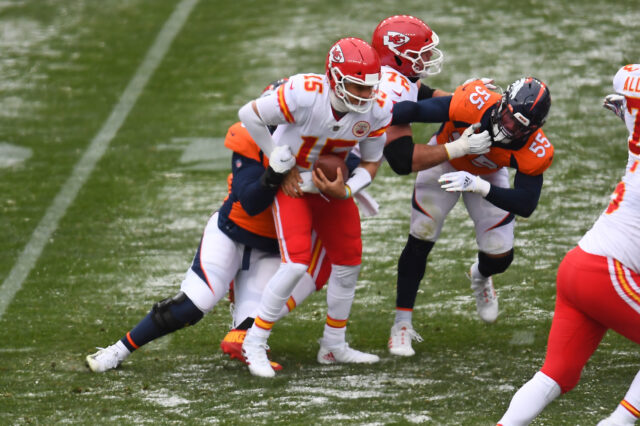 Kansas City Chiefs quarterback Patrick Mahomes (15) is sacked by Denver Broncos defensive end Dre'Mont Jones (93) in the first half at Empower Field at Mile High.