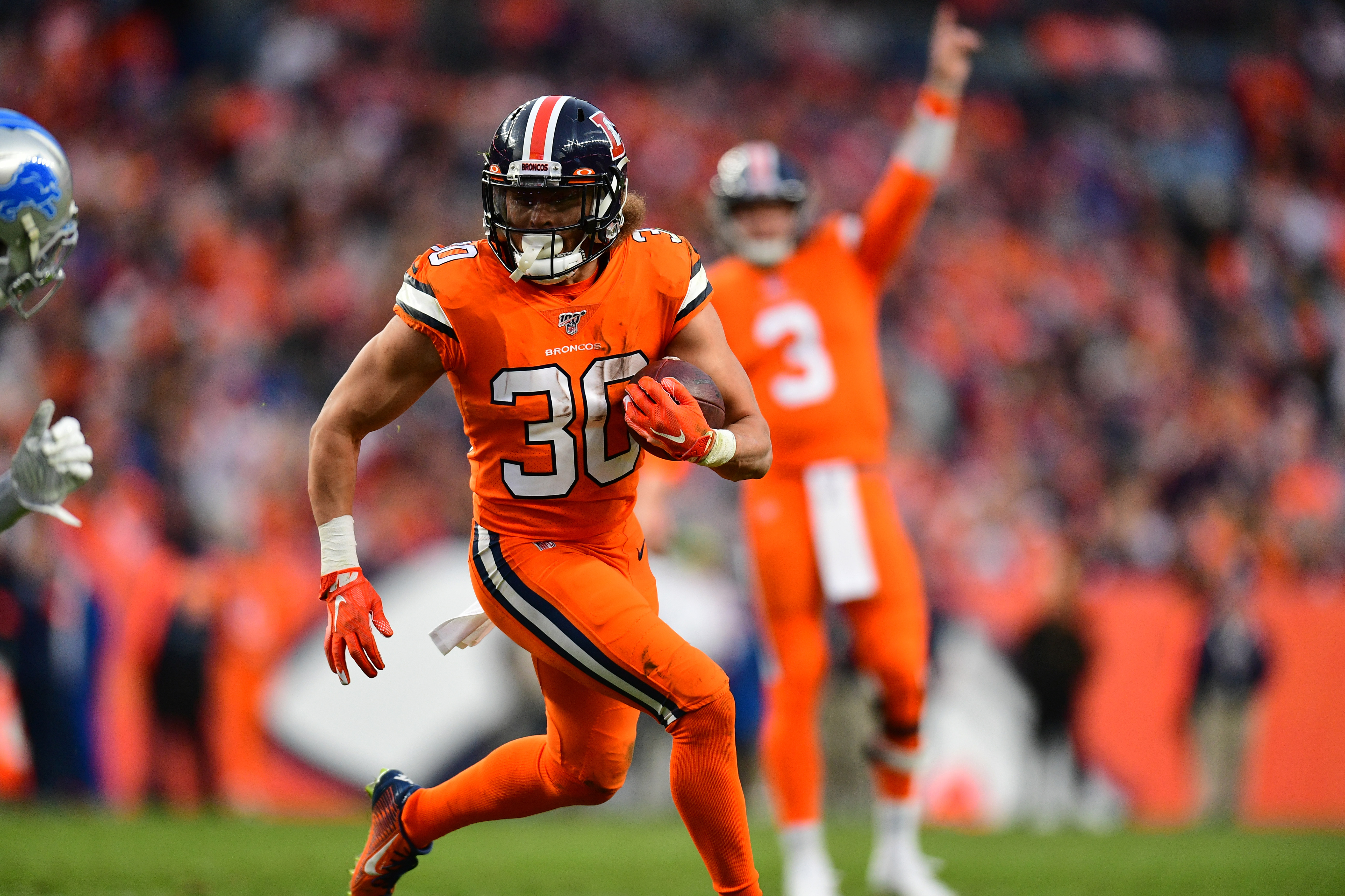 Denver Broncos running back Phillip Lindsay (30) carries the ball in the fourth quarter against the Detroit Lions at Empower Field at Mile High.