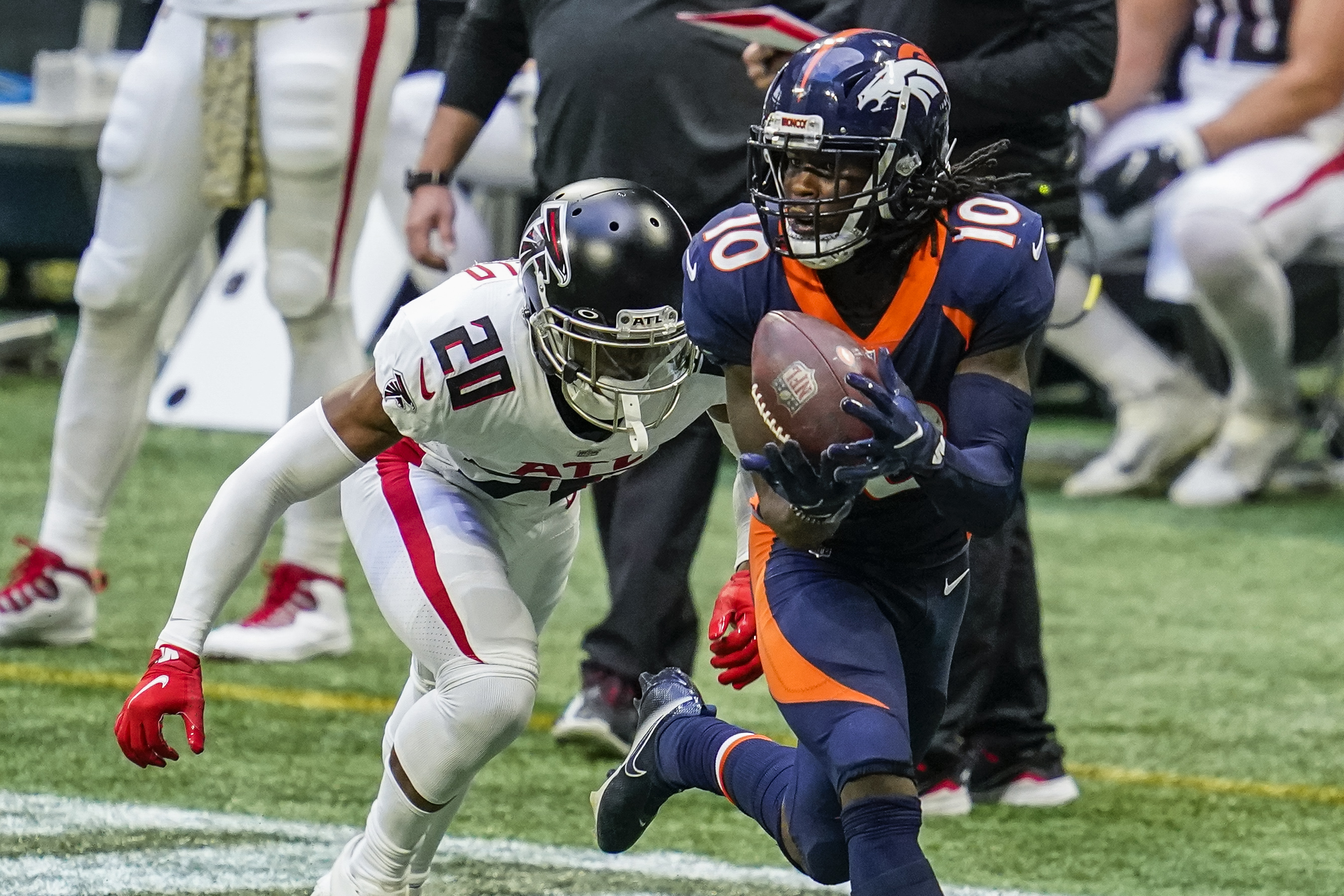 Denver Broncos wide receiver Jerry Jeudy (10) catches a long pass behind Atlanta Falcons cornerback Kendall Sheffield (20) during the second half at Mercedes-Benz Stadium.