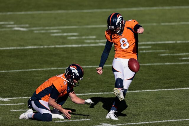 Denver Broncos kicker Brandon McManus (8) practices field goals as punter Sam Martin (6) holds the ball before the game against the Miami Dolphins at Empower Field at Mile High.