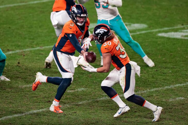Denver Broncos quarterback Drew Lock (3) hands the ball off to running back Phillip Lindsay (30) in the fourth quarter against the Miami Dolphins at Empower Field at Mile High.
