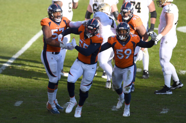 Denver Broncos outside linebacker Bradley Chubb (55) celebrates his sack with outside linebacker Malik Reed (59) and defensive end DeMarcus Walker (57) in the first quarter against the New Orleans Saints at Empower Field at Mile High.