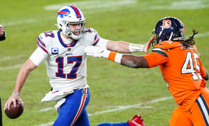 Buffalo Bills quarterback Josh Allen (17) stiff arms Denver Broncos linebacker A.J. Johnson (45) during the third quarter at Empower Field at Mile High.