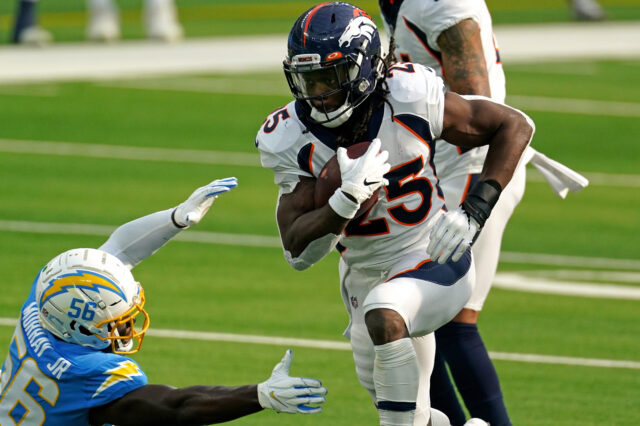 Denver Broncos running back Melvin Gordon (25) runs the ball as Los Angeles Chargers outside linebacker Kenneth Murray (56) attempts to make the tackle during the first half at SoFi Stadium.