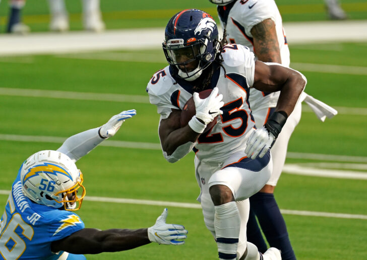 Denver Broncos running back Melvin Gordon (25) runs the ball as Los Angeles Chargers outside linebacker Kenneth Murray (56) attempts to make the tackle during the first half at SoFi Stadium.