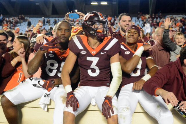 Virginia Tech Hokies defensive back Caleb Farley (3) tight end Chris Cunningham (85) and wide receiver Phil Patterson (8) celebrate with fans after a win against the North Carolina Tar Heels at Kenan Memorial Stadium. The Hokies won 22-19.