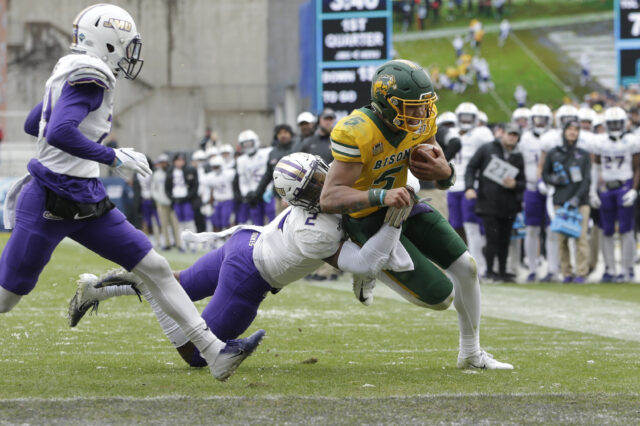 North Dakota State Bison quarterback Trey Lance (5) is tackled on the one yard line by James Madison Dukes linebacker Dimitri Holloway (2) in the first quarter at Toyota Stadium.
