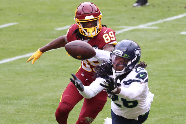 Seattle Seahawks cornerback Shaquill Griffin (26) intercepts a pass in front of Washington Football Team wide receiver Cam Sims (89) in the second quarter at FedExField.