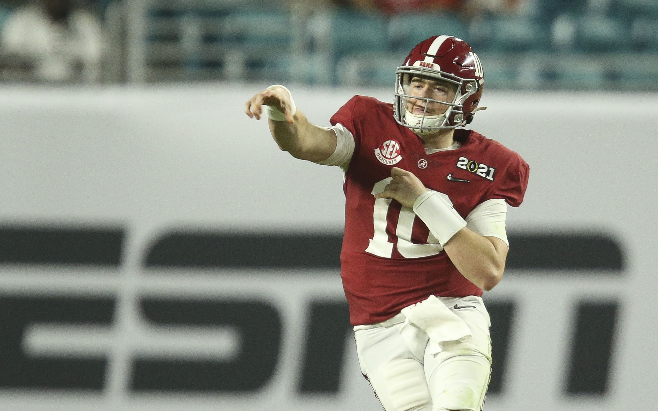 Mac Jones throws on the run. Credit: Gary Cosby, USA TODAY Sports.