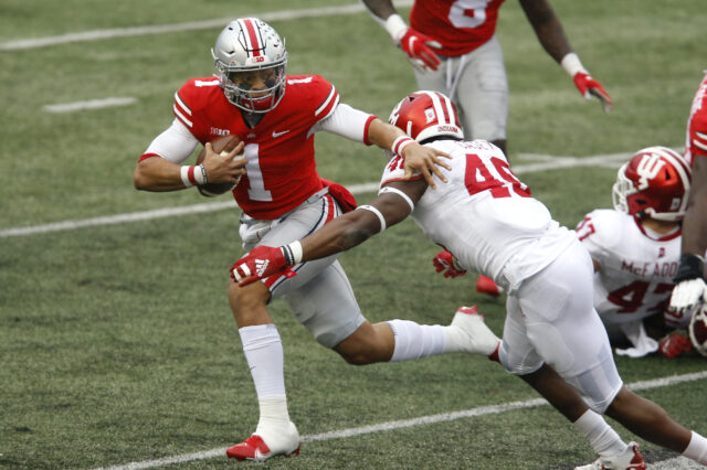 Ohio State Buckeyes quarterback Justin Fields (1) runs while defended by Indiana Hoosiers linebacker Aaron Casey (46) during the second quarter at Ohio Stadium.