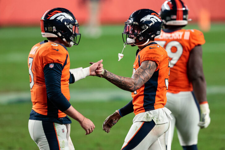 Denver Broncos quarterback Drew Lock (3) reacts with safety Justin Simmons (31) after the game against the Miami Dolphins at Empower Field at Mile High.
