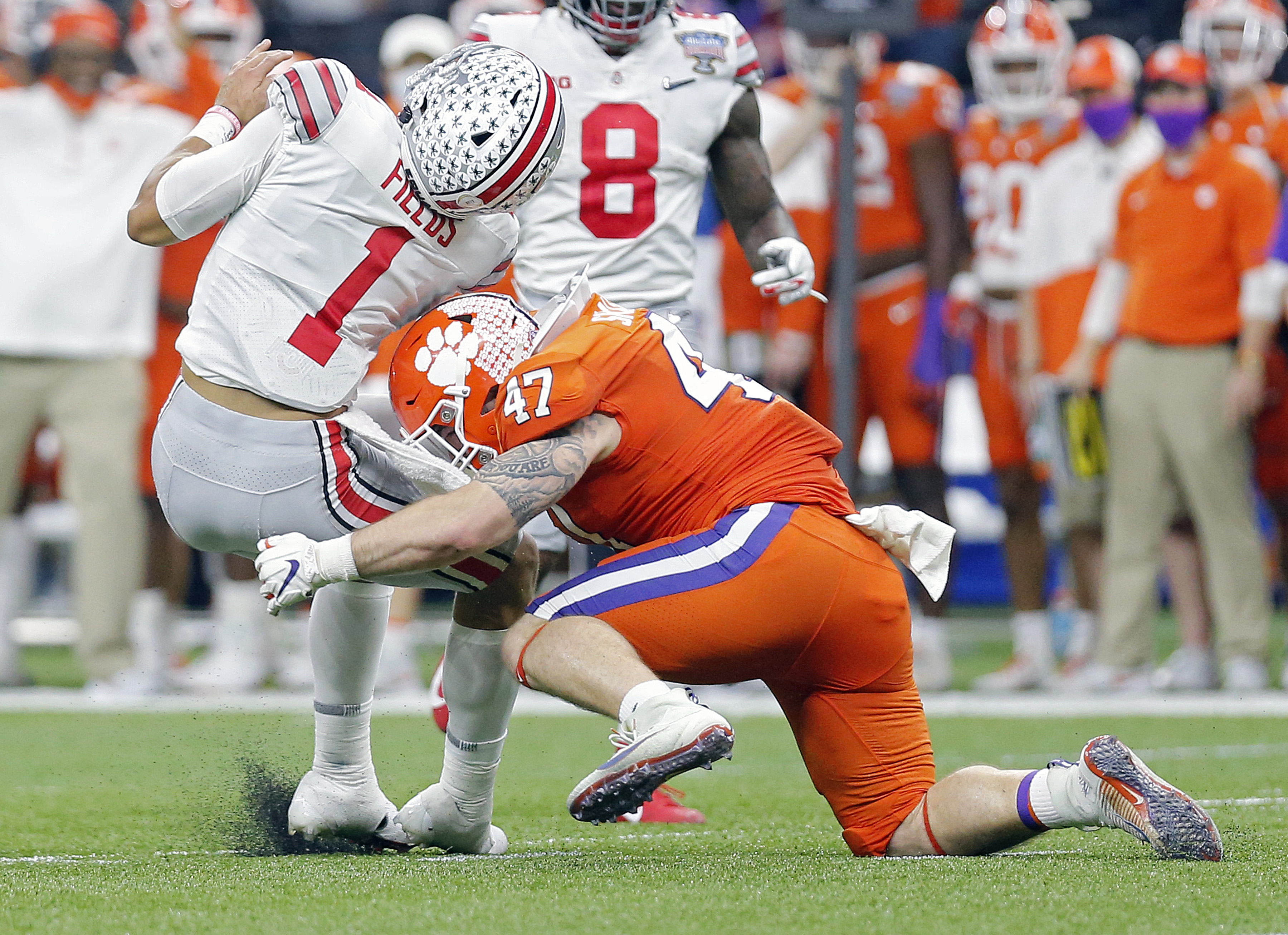 Ohio State Buckeyes quarterback Justin Fields (1) gets hit by Clemson Tigers linebacker James Skalski (47) in the second quarter during the College Football Playoff semifinal at the Allstate Sugar Bowl in the Mercedes-Benz Superdome in New Orleans on Friday, Jan. 1, 2021. Skalski was called for targeting on the play and kicked out of the game.