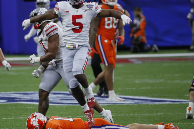 Ohio State Buckeyes linebacker Baron Browning (5) celebrates a fourth down stop as he leaps over Clemson Tigers quarterback Trevor Lawrence (16) during the fourth quarter of the College Football Playoff semifinal at the Allstate Sugar Bowl in the Mercedes-Benz Superdome in New Orleans on Friday, Jan. 1, 2021. Ohio State won 49-28