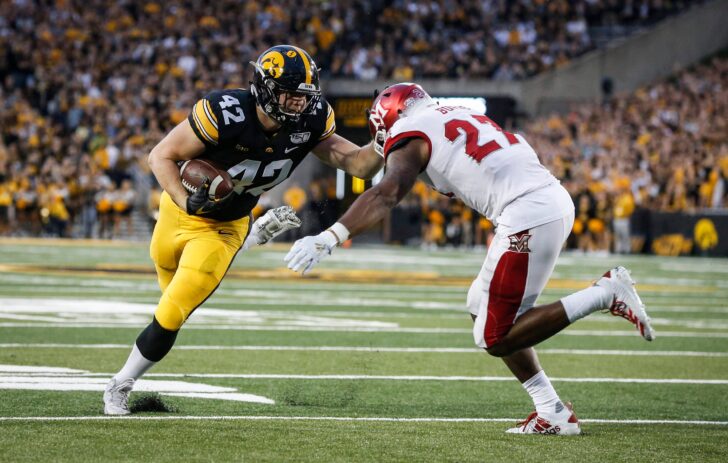 Iowa junior tight end Shaun Beyer takes the ball inside the five yard line before being tackled by Miami of Ohio linebacker Kobe Burse in the first quarter at Kinnick Stadium in Iowa City on Saturday, Aug. 31, 2019.