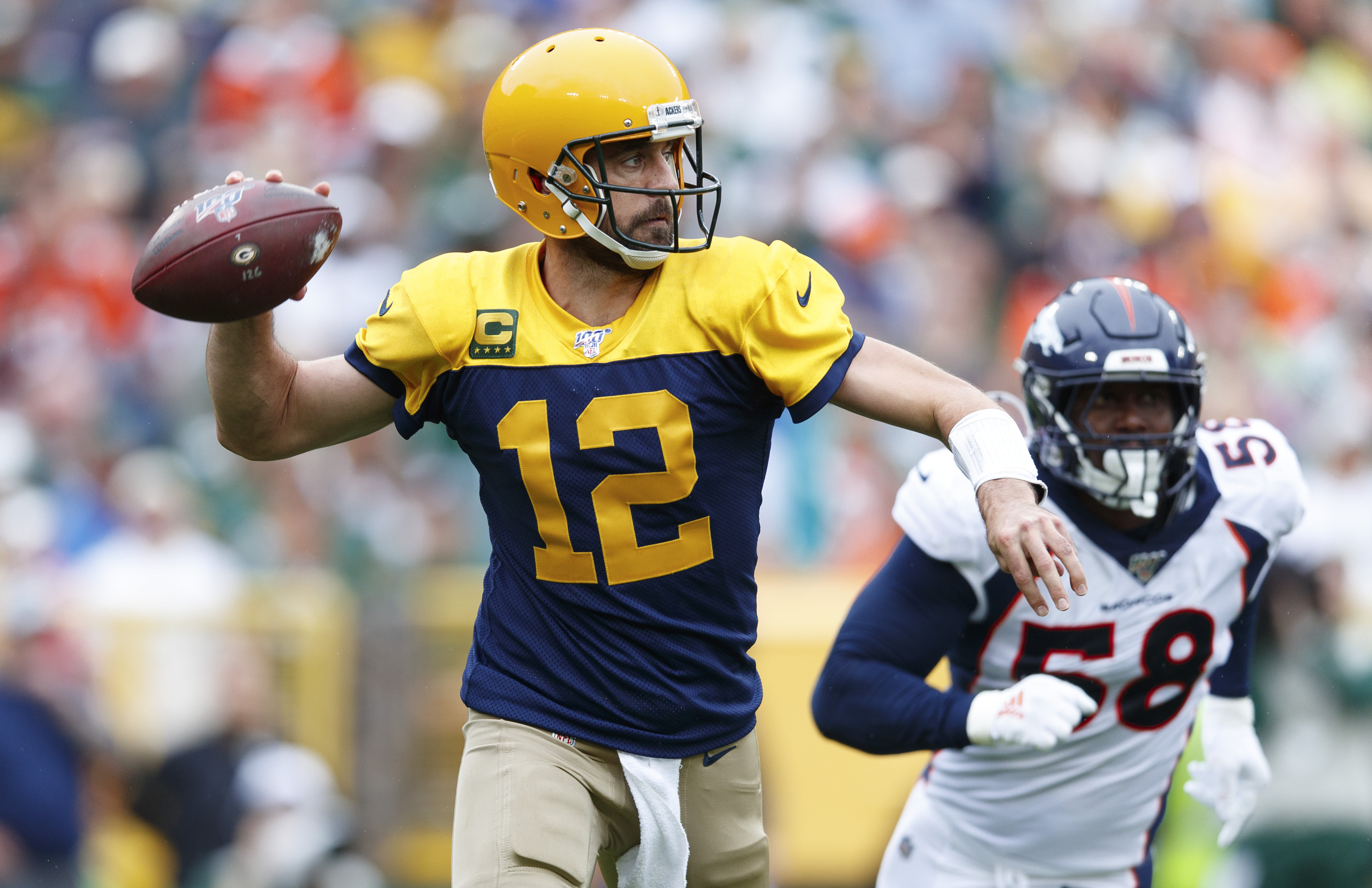 NFL: Denver Broncos at Green Bay Packers Green Bay Packers quarterback Aaron Rodgers (12) throws a pass under pressure from Denver Broncos linebacker Von Miller (58) during the second quarter at Lambeau Field.