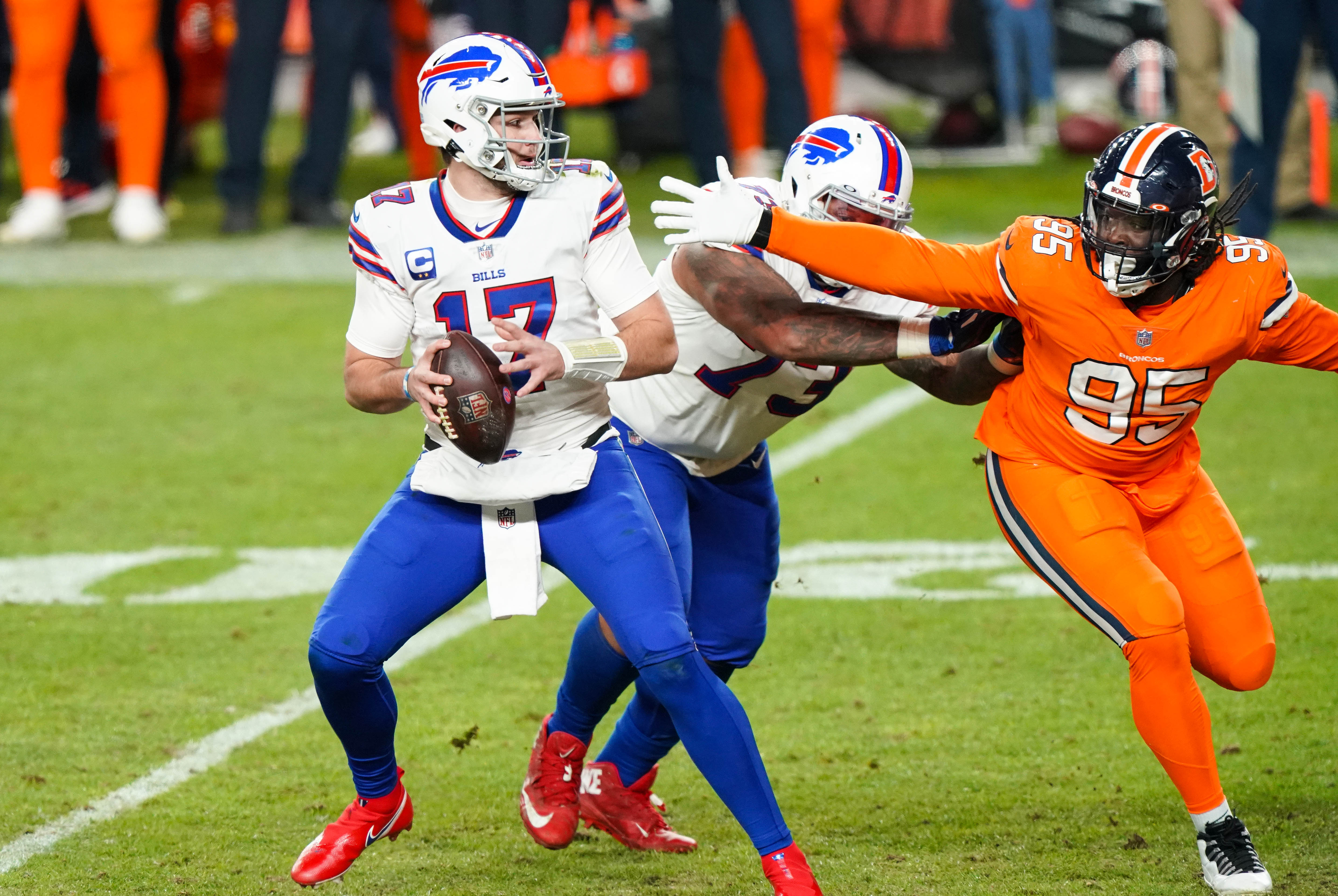Buffalo Bills quarterback Josh Allen (17) looks to throw against Denver Broncos defensive tackle McTelvin Agim (95) during the third quarter at Empower Field at Mile High.