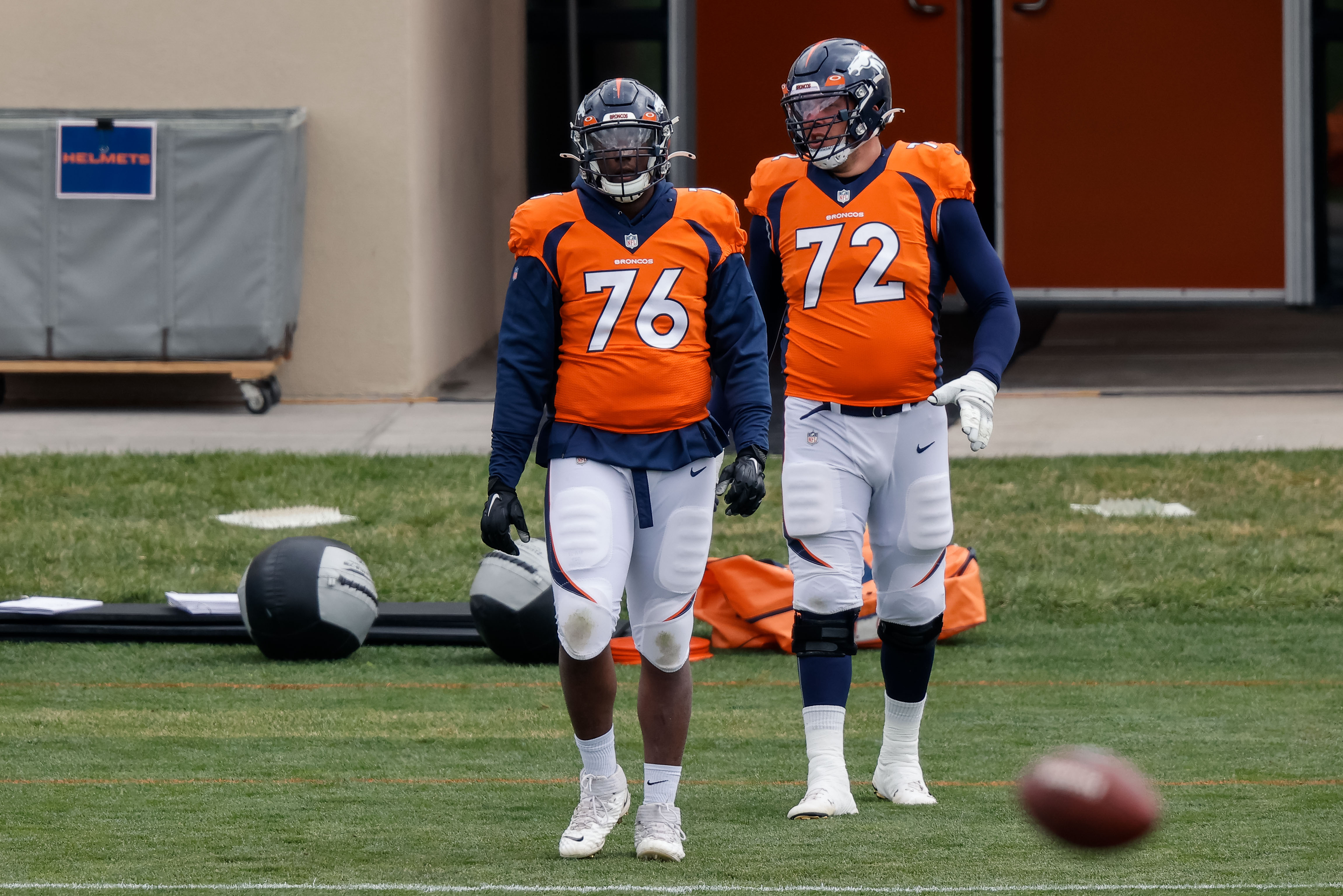 Denver Broncos offensive tackle Calvin Anderson (76) and offensive tackle Garett Bolles (72) during practice at UCHealth Training Center.