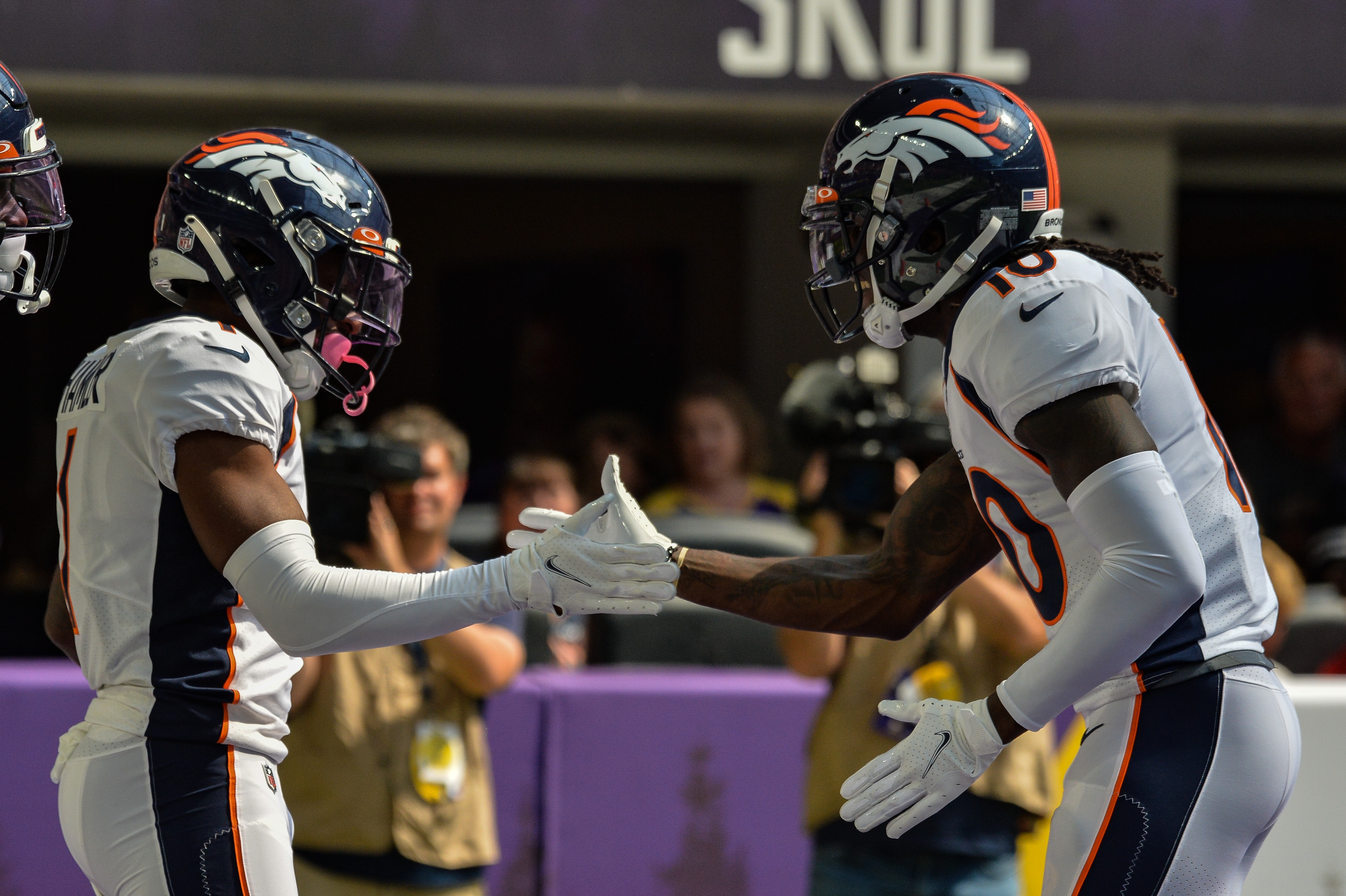 Denver Broncos wide receiver K.J. Hamler (1) and wide receiver Jerry Jeudy (right) react after a touchdown reception by Hamler against the Minnesota Vikings during the first quarter at U.S. Bank Stadium.