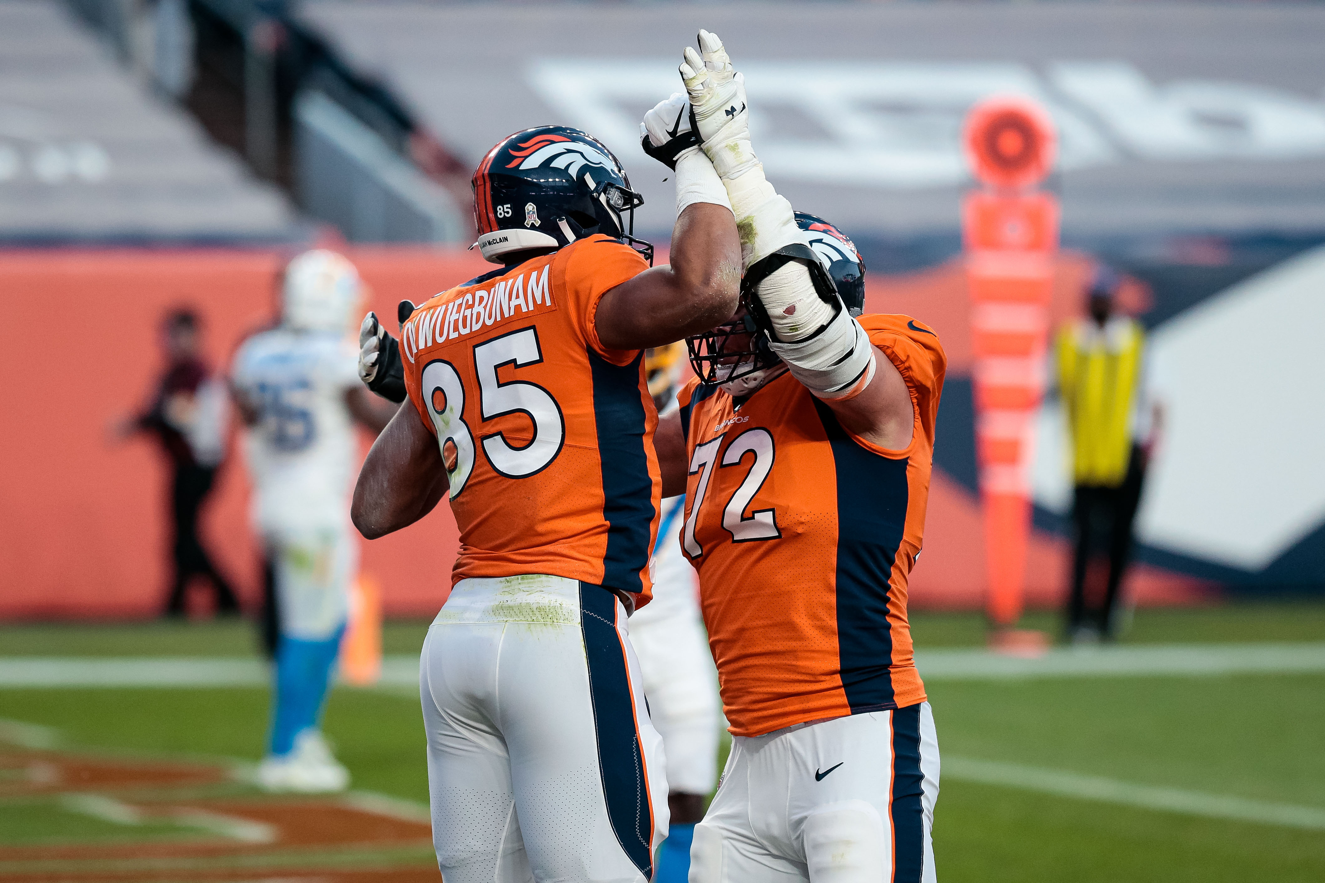 Denver Broncos tight end Albert Okwuegbunam (85) celebrates his touchdown with offensive tackle Garett Bolles (72) in the fourth quarter against the Los Angeles Chargers at Empower Field at Mile High.