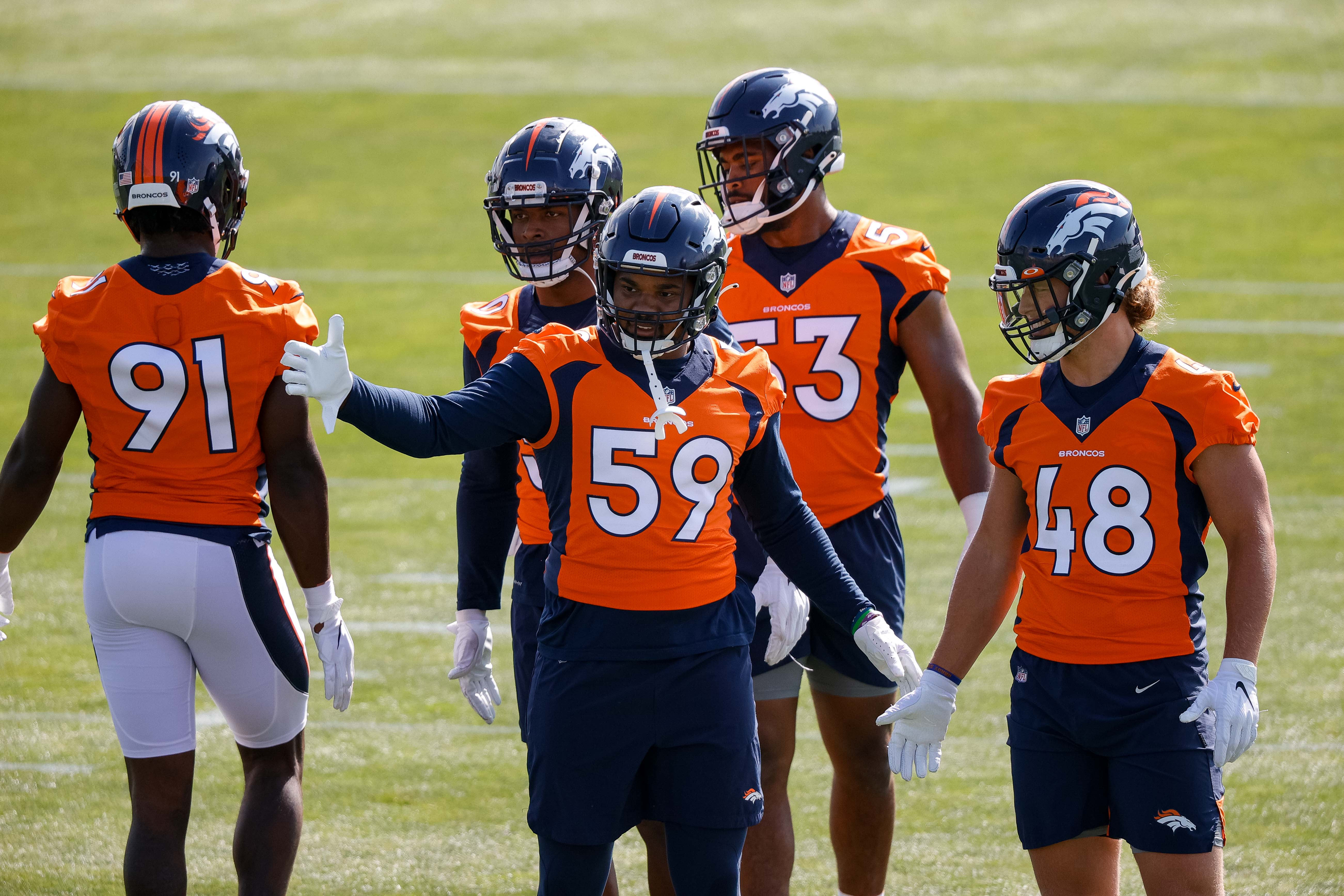 Denver Broncos outside linebacker Malik Reed (59) with Derrek Tuszka (48) and Jonathon Cooper (53) and Patrick Morris (50) and Andre Mintze (91) during training camp at UCHealth Training Center.