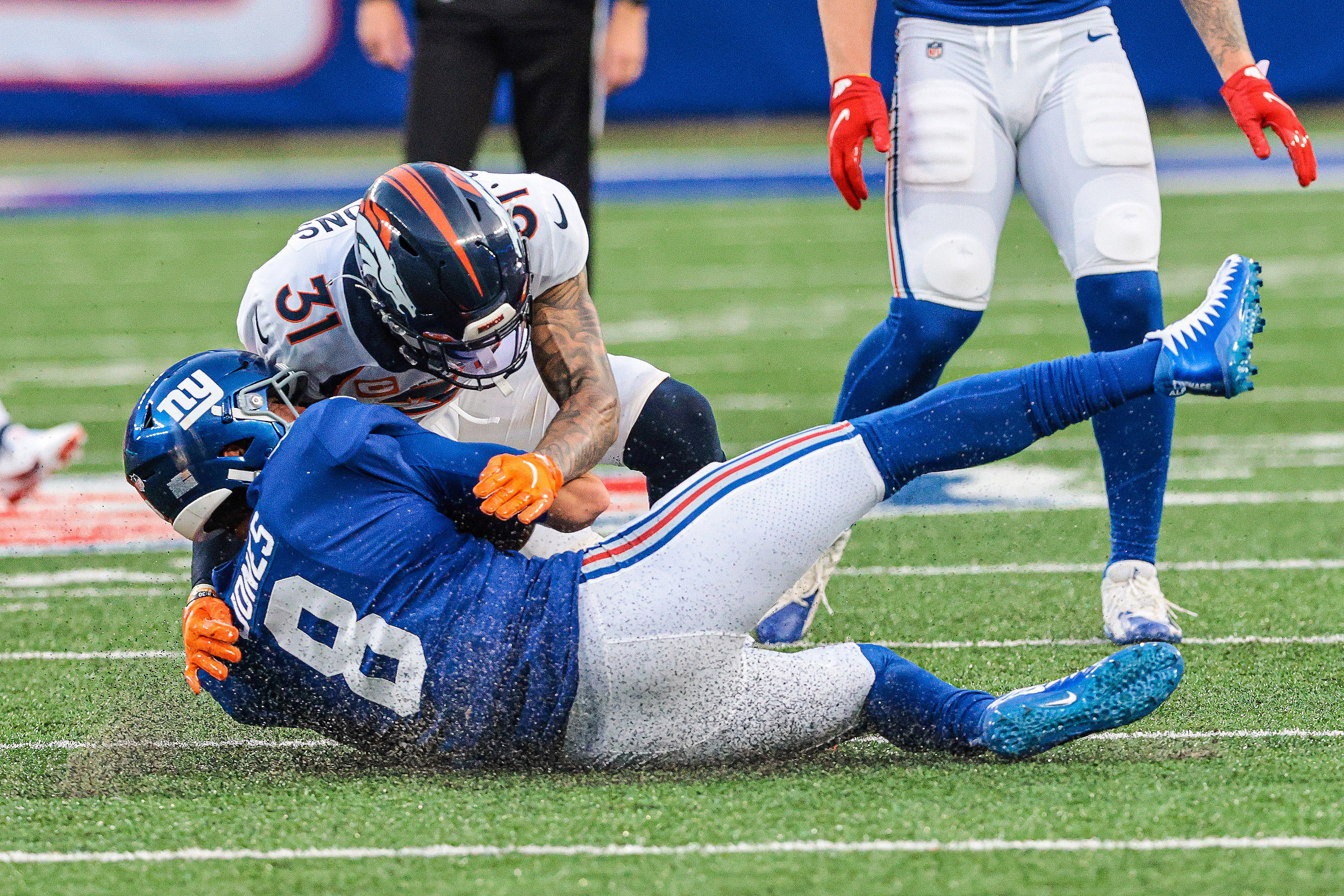 NFL: Denver Broncos at New York Giants Denver Broncos free safety Justin Simmons (31) tackles New York Giants quarterback Daniel Jones (8) during the second half at MetLife Stadium.
