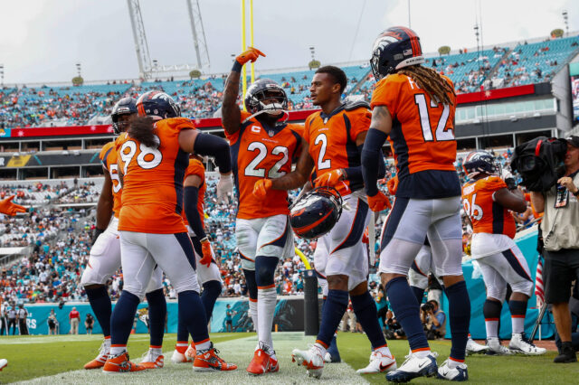 Denver Broncos strong safety Kareem Jackson (22) celebrates after a reception by cornerback Pat Surtain II (2) in the fourth quarter against the Jacksonville Jaguars at TIAA Bank Field. Strong Position Group
