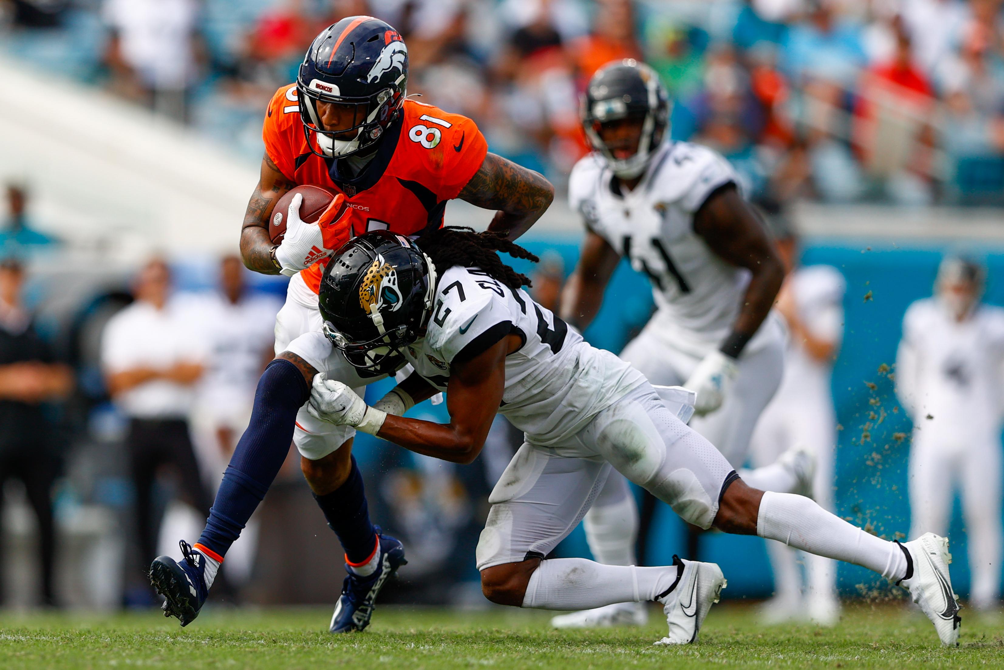 Denver Broncos wide receiver Tim Patrick (81) is tackled by Jacksonville Jaguars cornerback Chris Claybrooks (27) in the fourth quarter at TIAA Bank Field.