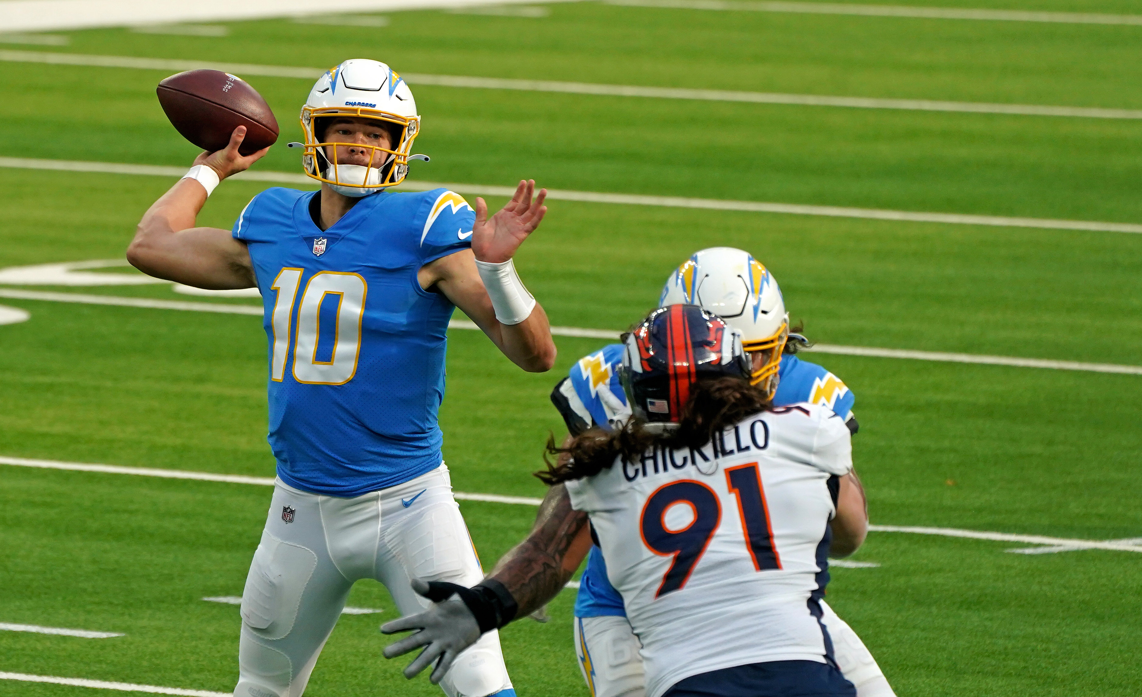 Los Angeles Chargers quarterback Justin Herbert (10) throws a pass against the Denver Broncos during the first half at SoFi Stadium.