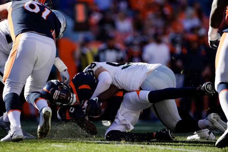 Denver Broncos quarterback Teddy Bridgewater (5) is sacked by Las Vegas Raiders defensive end Maxx Crosby (98) in the second quarter at Empower Field at Mile High.