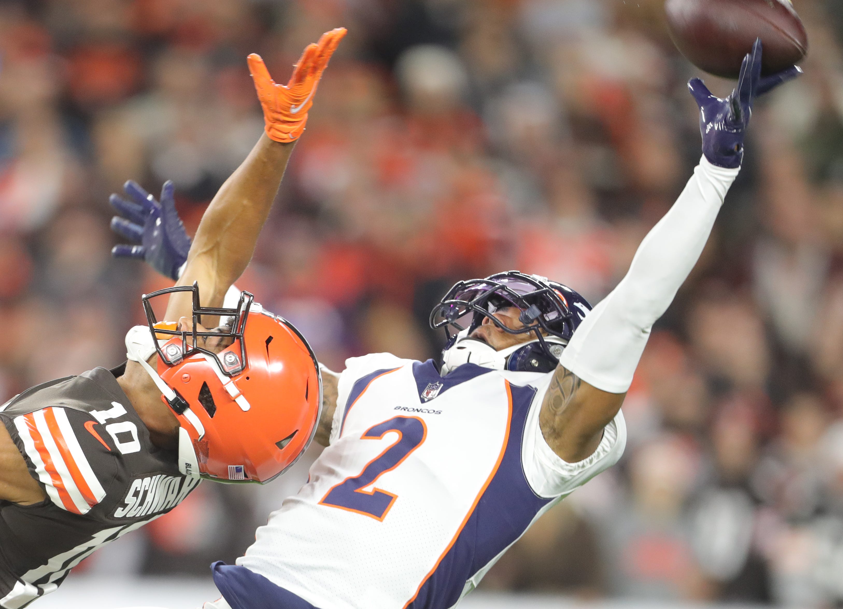 Cleveland Browns' Anthony Schwartz can't get to a deep ball as Denver Broncos' Par Surtain II defends on Thursday, Oct. 21, 2021 in Cleveland, Ohio, at FirstEnergy Stadium.