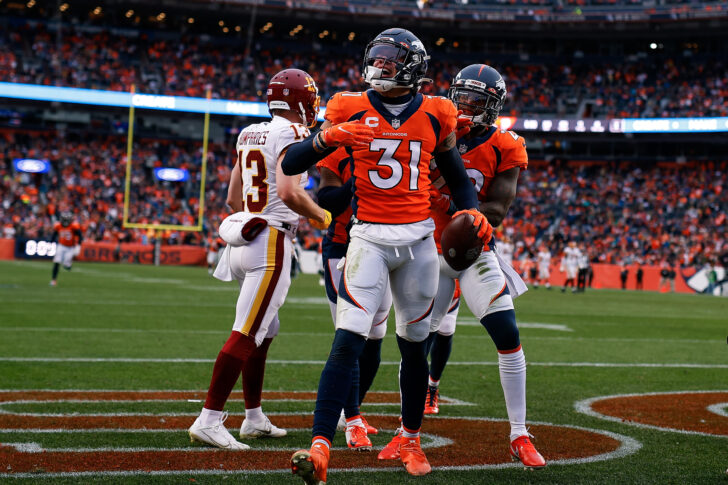 Denver Broncos safety Justin Simmons (31) celebrates with safety Kareem Jackson (22) after an interception in the second quarter against the Washington Football Team at Empower Field at Mile High.