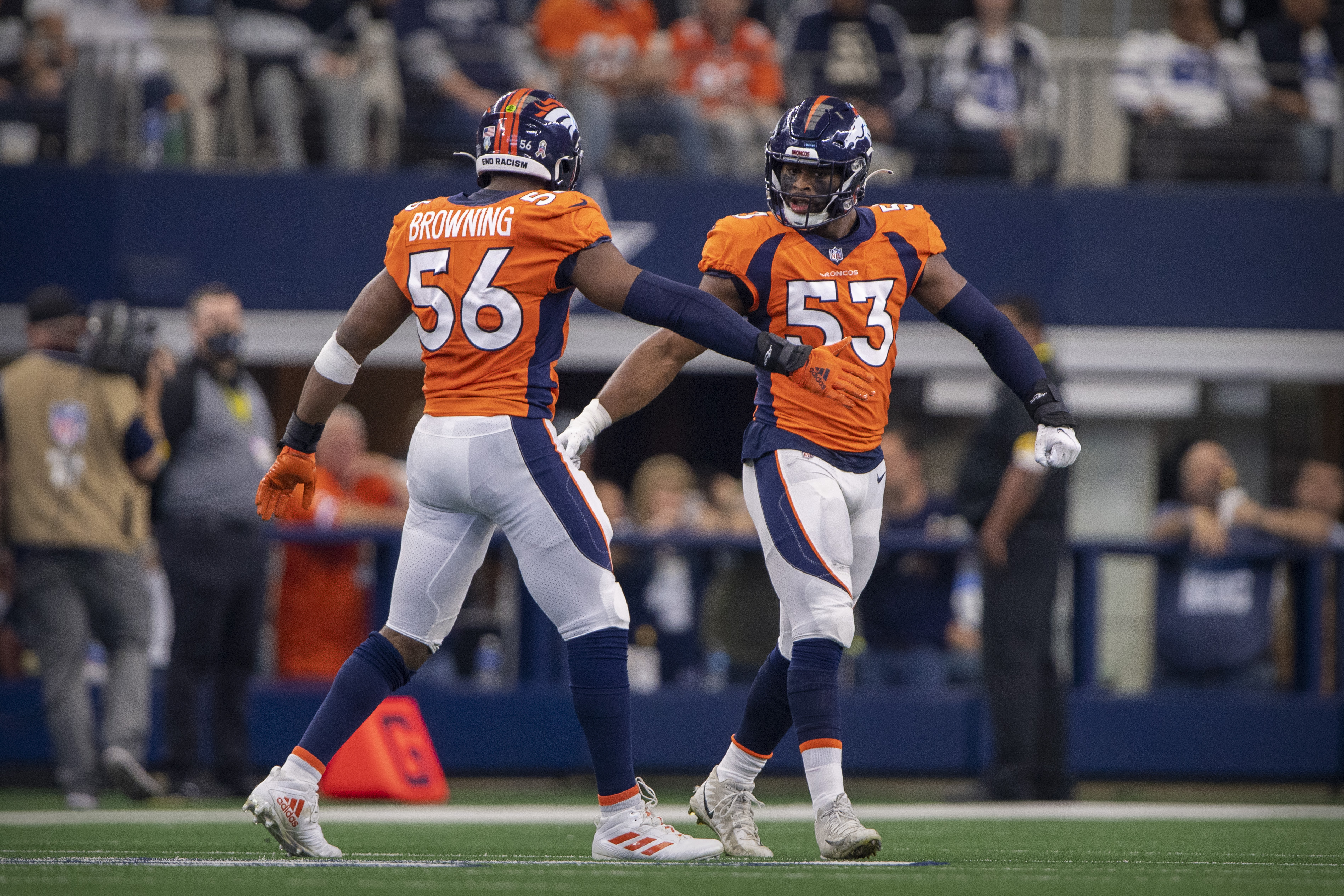 Denver Broncos linebacker Baron Browning (56) and linebacker Jonathon Cooper (53) celebrate a sack against the Dallas Cowboys during the second quarter at AT&T Stadium.