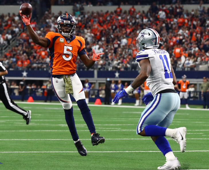 Denver Broncos quarterback Teddy Bridgewater (5) throws on the run for a two point conversion in the fourth quarter against Dallas Cowboys linebacker Micah Parsons (11) at AT&T Stadium.