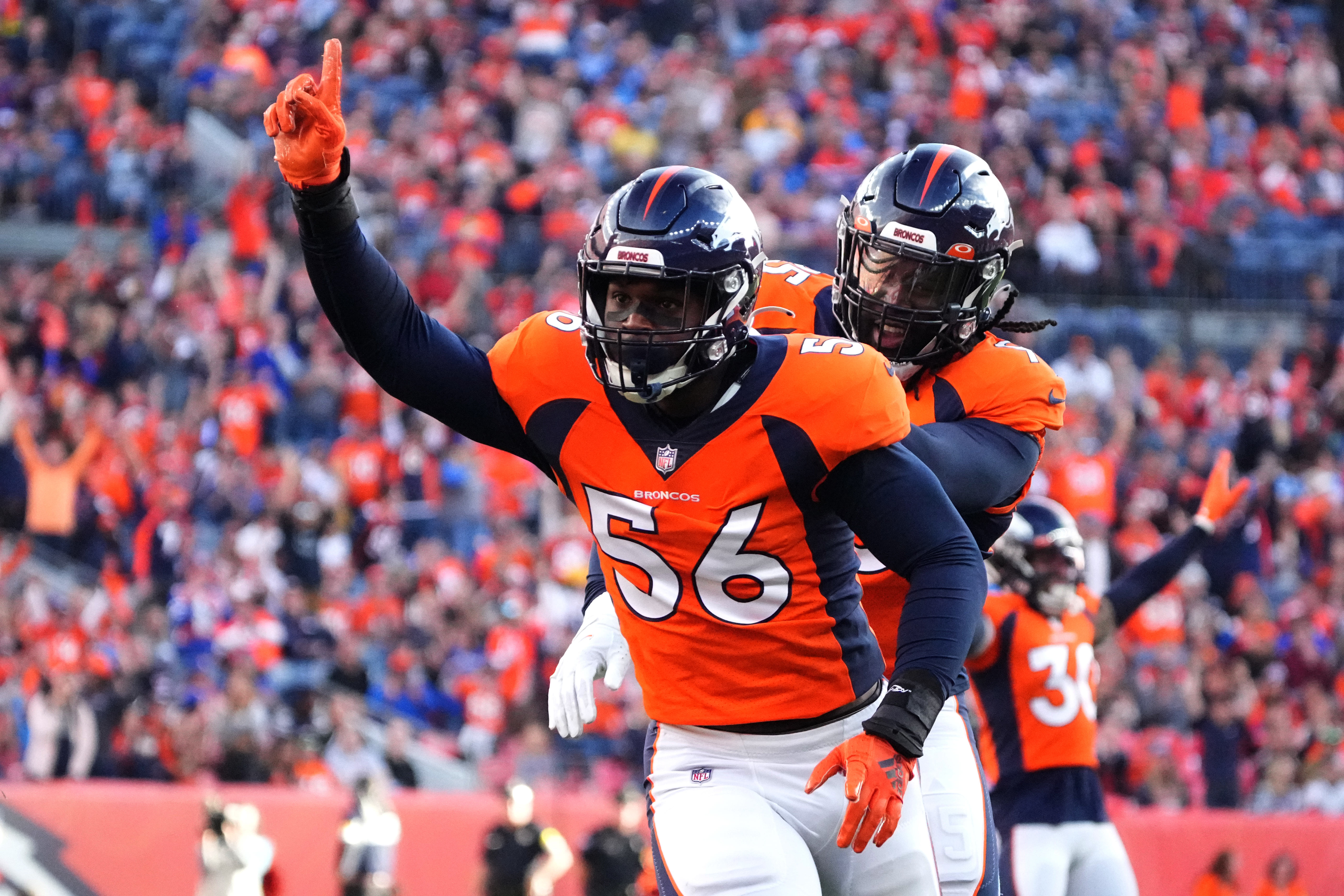 Denver Broncos inside linebacker Baron Browning (56) reacts to his tipped pass in the first quarter against the Los Angeles Chargers at Empower Field at Mile High.