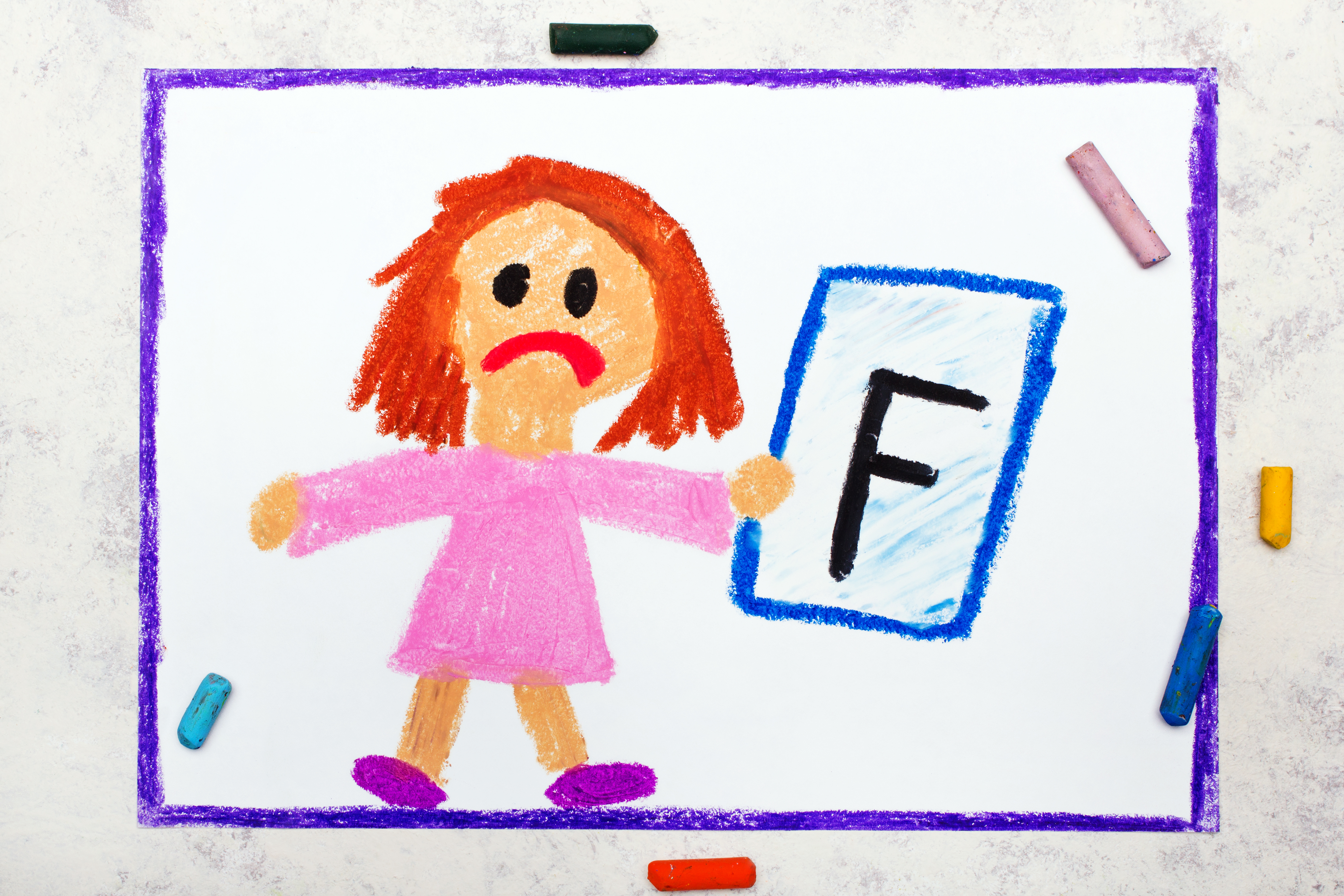 School grades. Sad student with exam or test result. Girl holding report card with F grade. Photo of colorful hand drawing.