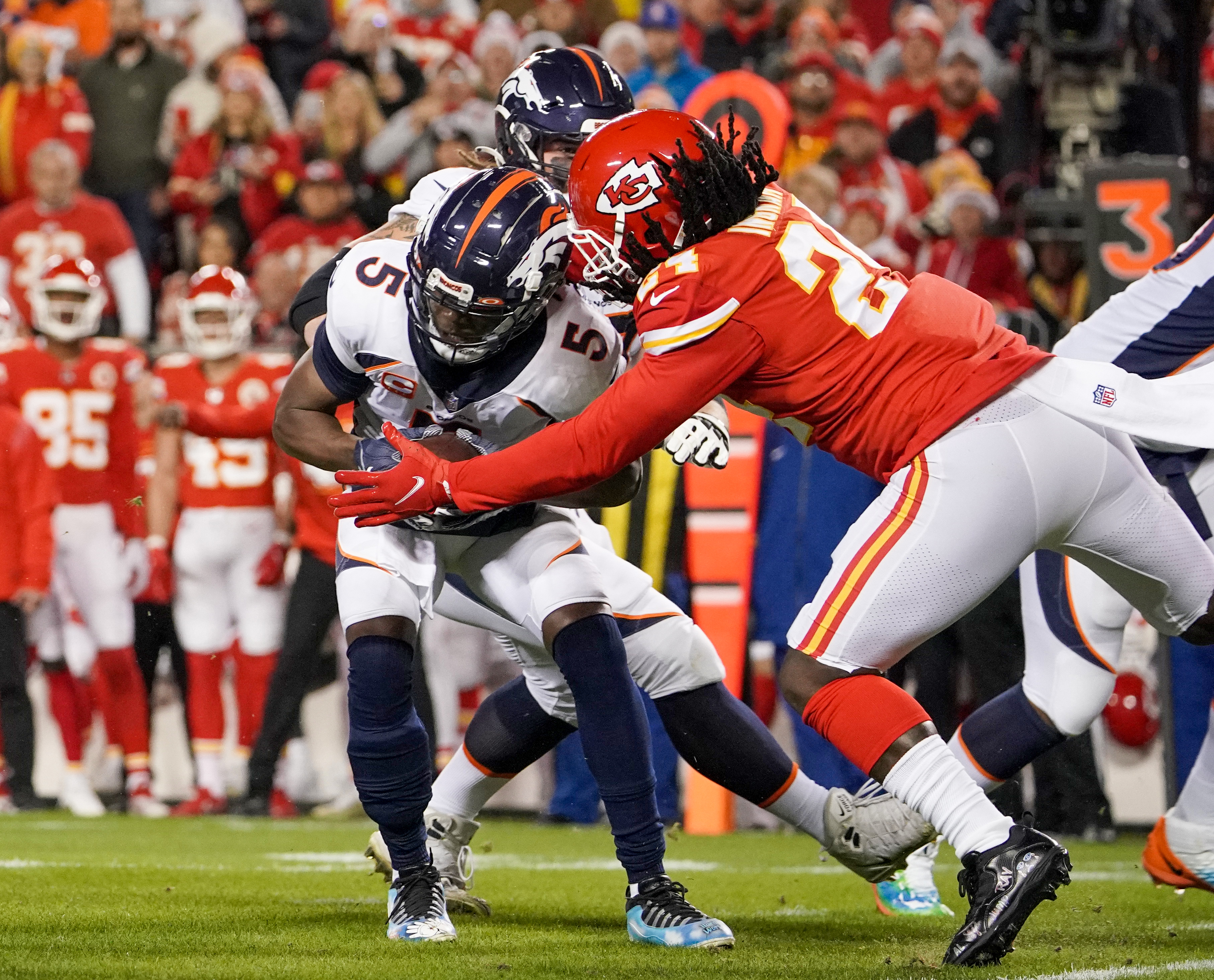Denver Broncos quarterback Teddy Bridgewater (5) is sacked by Kansas City Chiefs linebacker Melfvin Ingram (24) during the first half at GEHA Field at Arrowhead Stadium.