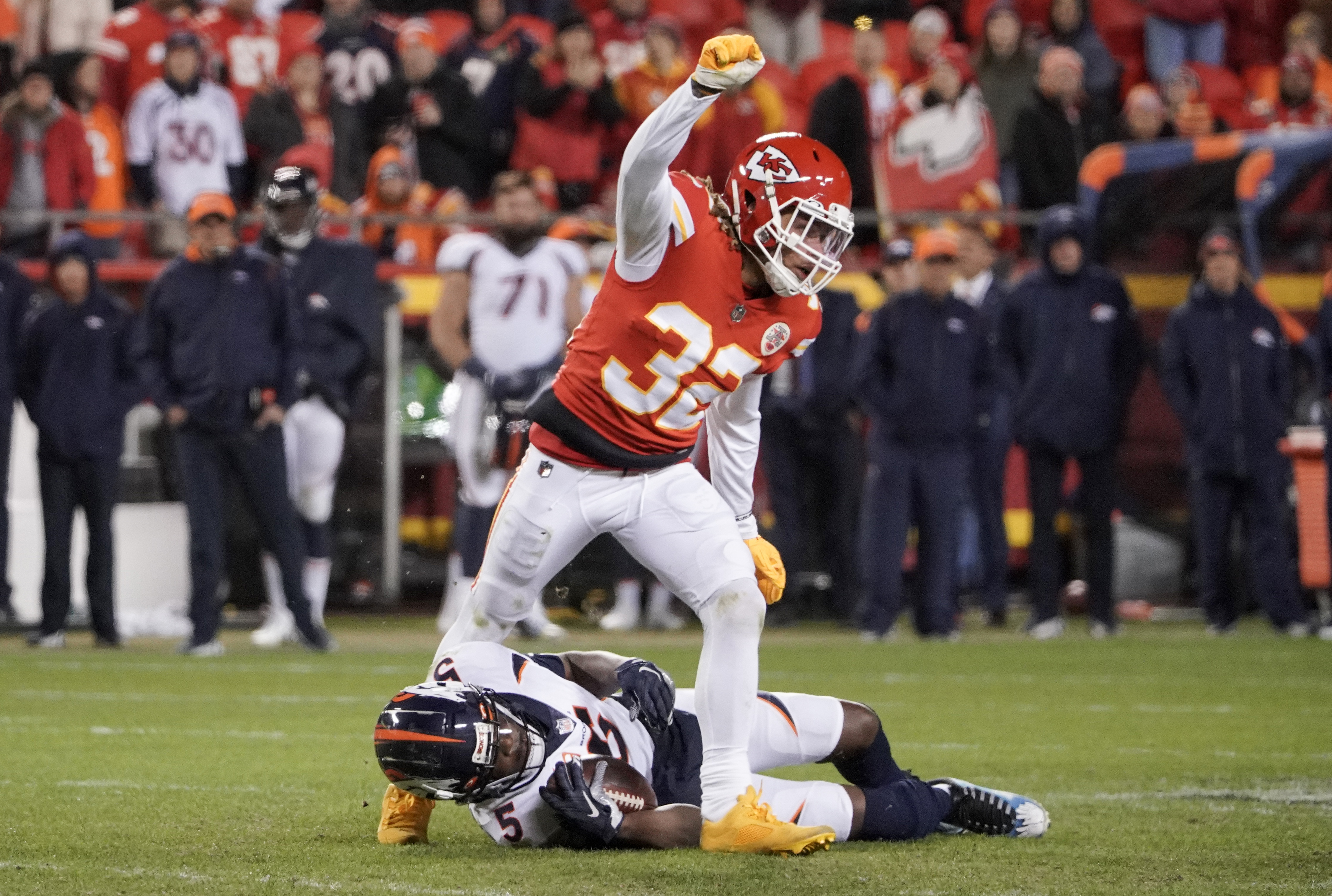 Kansas City Chiefs free safety Tyrann Mathieu (32) celebrates as he leaps over Denver Broncos quarterback Teddy Bridgewater (5) during the second half at GEHA Field at Arrowhead Stadium.