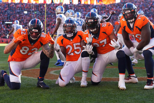 Denver Broncos running back Melvin Gordon III (25) celebrates his touchdown carry with teammates tight end Eric Saubert (82) and tight end Noah Fant (87) and Lloyd Cushenberry III (79) in the first quarter against the Detroit Lions at Empower Field at Mile High.