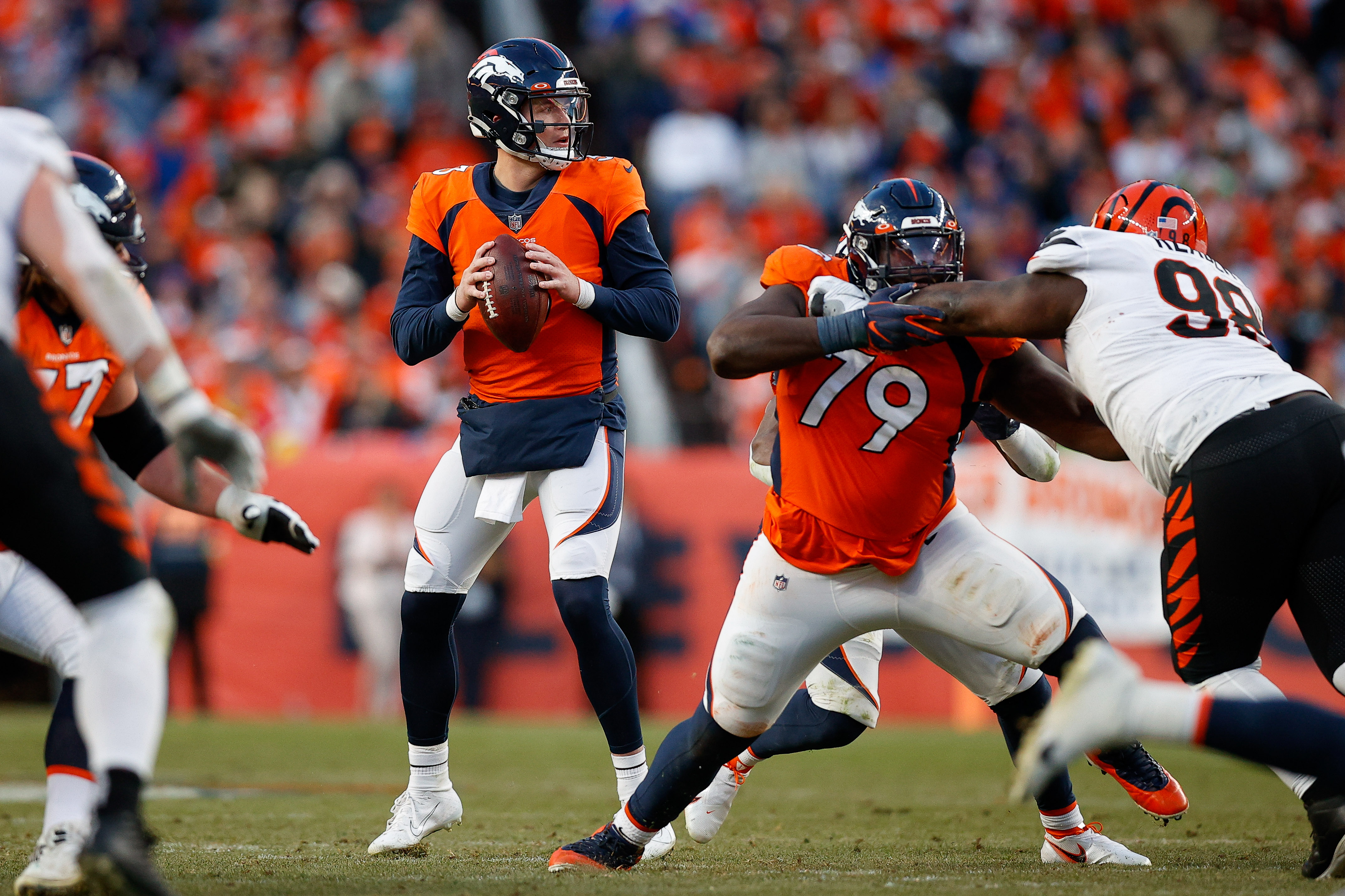 Denver Broncos quarterback Drew Lock (3) looks to pass as center Lloyd Cushenberry III (79) defends against Cincinnati Bengals defensive tackle Tyler Shelvin (99) in the third quarter at Empower Field at Mile High.