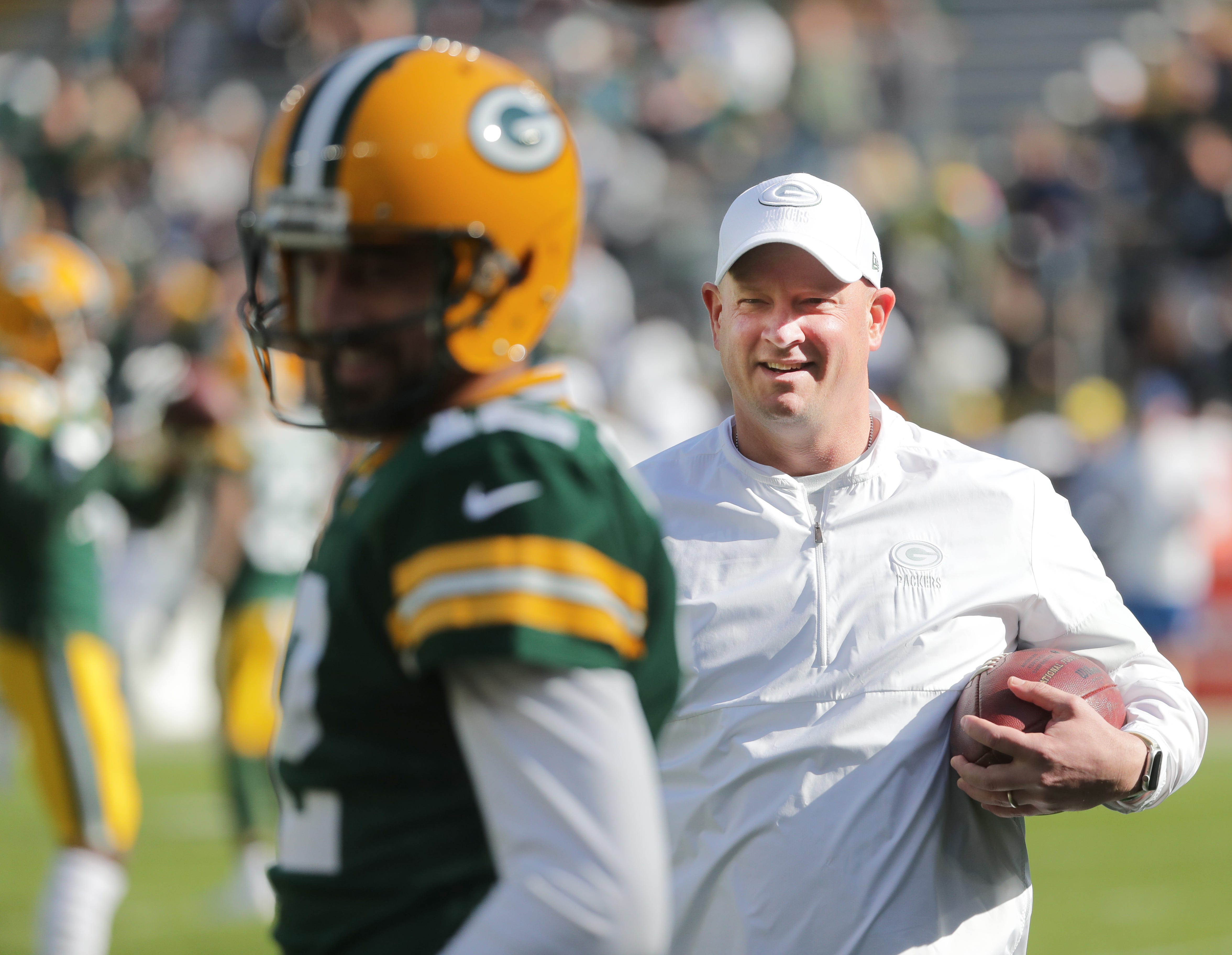 Green Bay Packers offensive coordinator Nathaniel Hackett talks with quarterback Aaron Rodgers (12) before their game against the Oakland Raiders Sunday, October 21, 2019 at Lambeau Field in Green Bay, Wis.