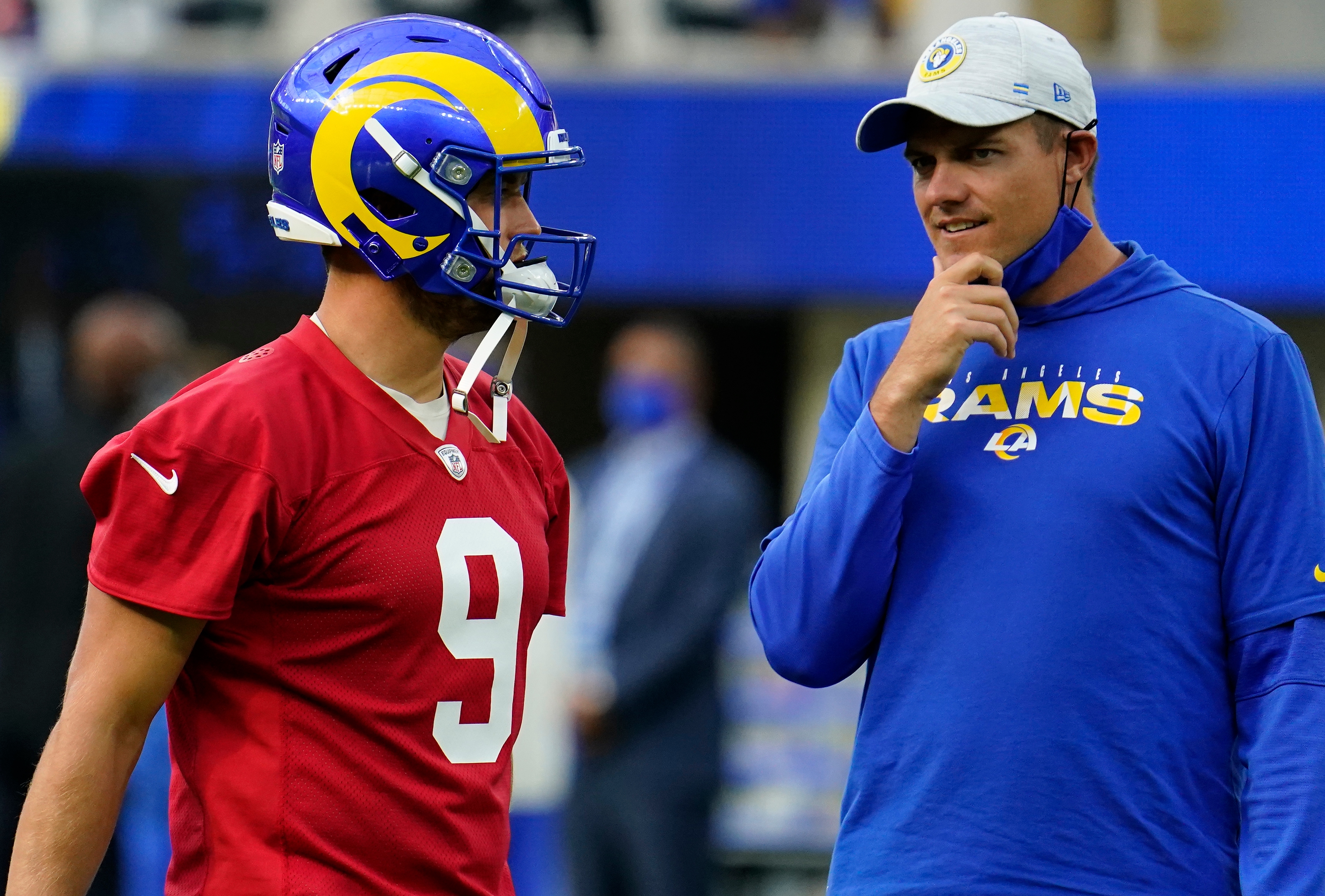 Los Angeles Rams quarterback Matthew Stafford (9) talks to offensive coordinator Kevin O'Connell during an offseason workout at SoFi Stadium.