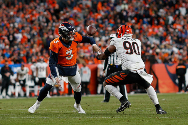Cincinnati Bengals defensive end Khalid Kareem (90) strips the ball from Denver Broncos quarterback Drew Lock (3) in the fourth quarter at Empower Field at Mile High.