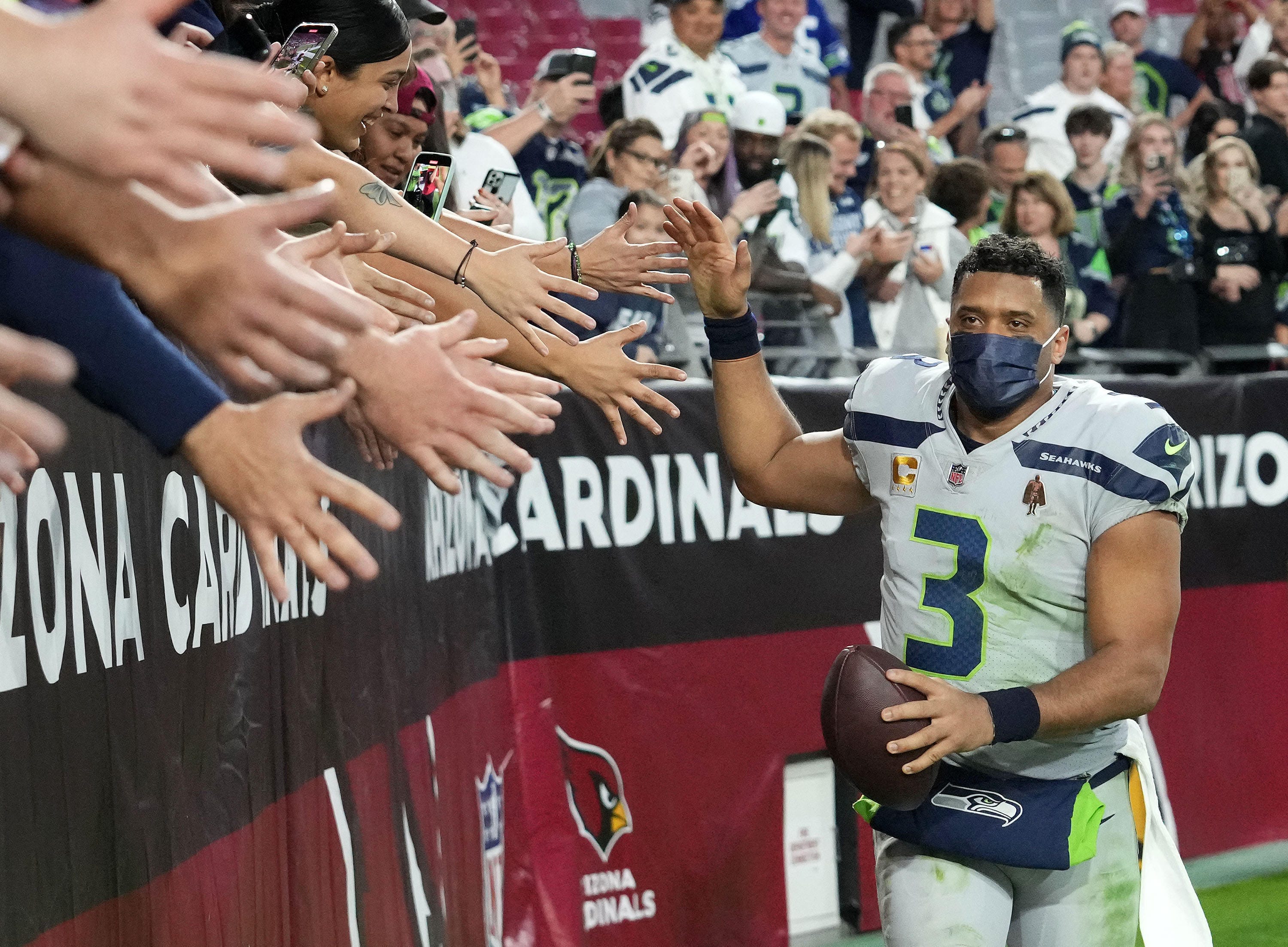 Seattle Seahawks quarterback Russell Wilson (3) greets the fans after defeating the Arizona Cardinals at State Farm Stadium.
