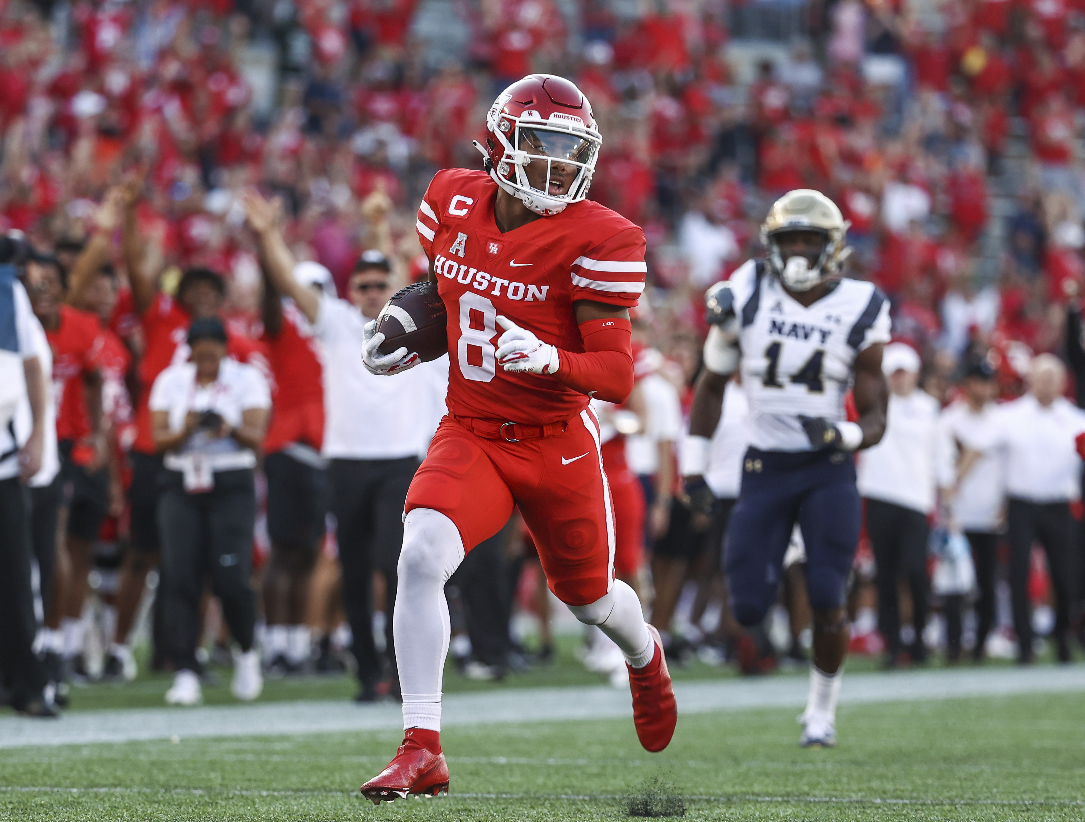 Houston Cougars cornerback Marcus Jones (8) returns a punt for a touchdown during the first quarter against the Navy Midshipmen at TDECU Stadium.