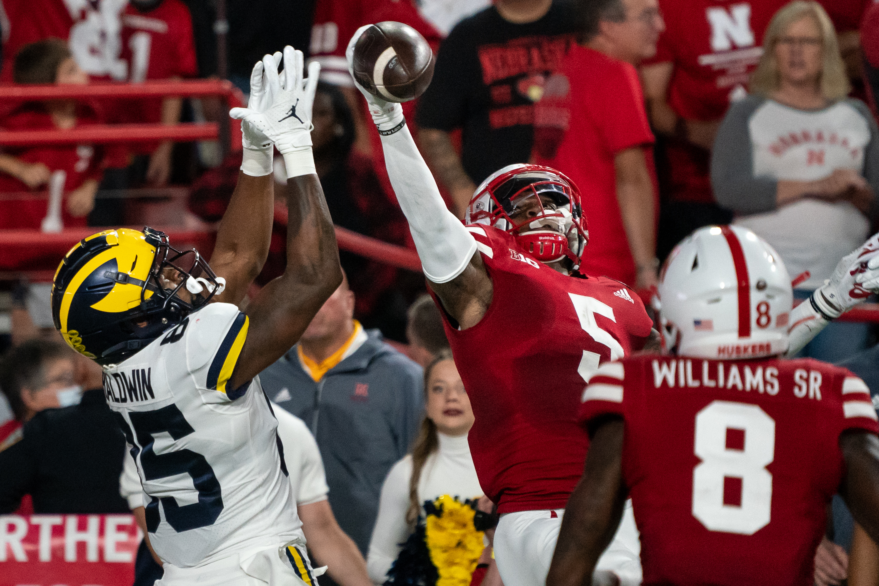 Nebraska Cornhuskers cornerback Cam Taylor-Britt (5) breaks up a pass to Michigan Wolverines wide receiver Daylen Baldwin (85) during the second quarter at Memorial Stadium. 