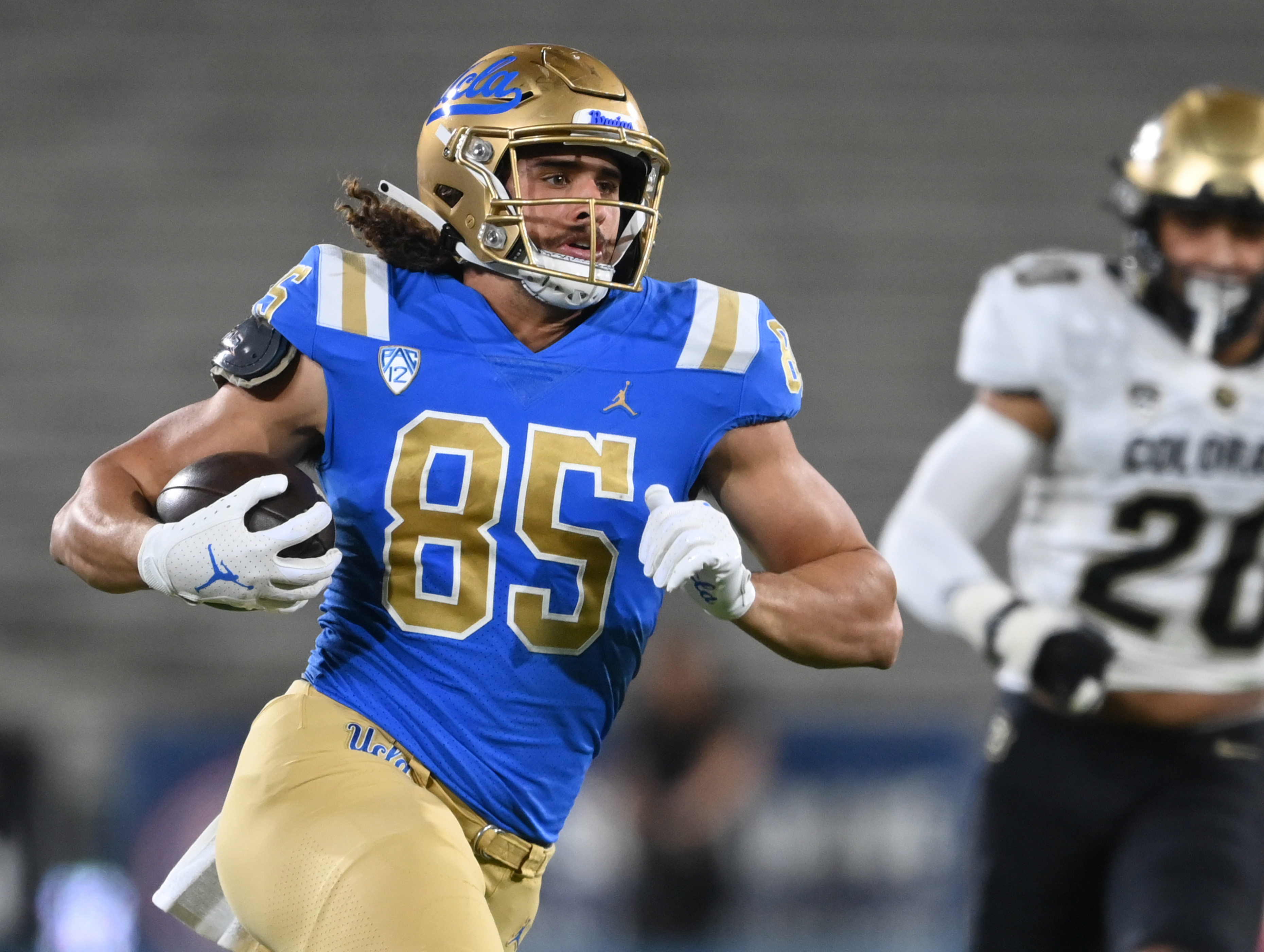 NCAA Football: Colorado at UCLA UCLA Bruins tight end Greg Dulcich (85) runs with the ball for a first down in the first half against the Colorado Buffaloes at Rose Bowl.
