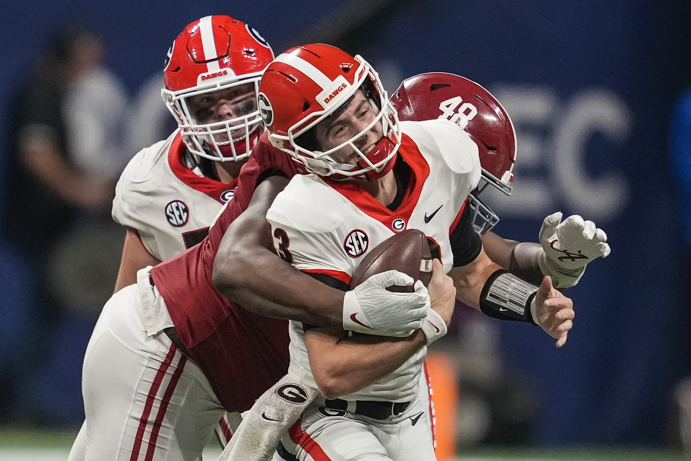 Georgia Bulldogs quarterback Stetson Bennett (13) is tackled for a loss by Alabama Crimson Tide defensive lineman Phidarian Mathis (48) during the second half at Mercedes-Benz Stadium. 