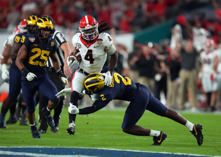 Georgia Bulldogs running back James Cook (4) runs the ball against the Michigan Wolverines during the first quarter in the Orange Bowl college football CFP national semifinal game at Hard Rock Stadium.